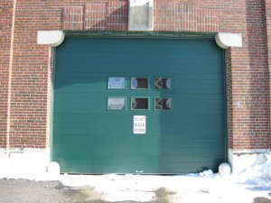 Green commercial garage door | Wiscasset, ME